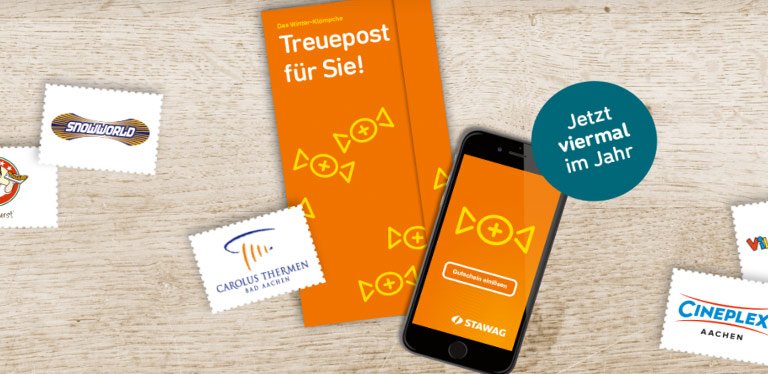 Verschiedene Treuepost Gutscheine liegen um Stawag Treuepost Flyer und mobile Phone